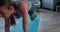 Zoom out on beautiful sporty young woman doing sweat fitness workout at home on yoga mat on quarantine self isolation.