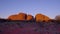 zoom out clip of kata tjuta a brilliant red at sunset in northern territory