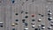 Zoom out Dolly Shot of Top view car Parking lot. Aerial view of many Cars Moving on parking. Car traffic and Parking