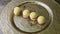 Zoom out from modernly decorated four spherical sponge biscuits on golden plate
