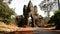 Zoom Out - Mopeds Drive through Archway on Bridge - Angkor Wat, Cambodia