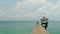 Zoom out pathway to pier on the sea at loneliness beach, full HD.