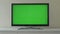 Zoom Out Shot of a TV with Horizontal Green Screen Mock Up. Living Room at Home.