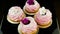 Zoom out from small group of pink marshmallow cookies