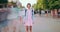 Zoom out time lapse of attractive female student standing in street alone