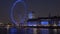 Zoom-out, time-lapse of the London Eye from across the river Thames