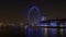 Zoom-out, time-lapse of the London Eye from across the river Thames