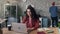 Zoom out time-lapse of young lady using laptop in shared office focused on job