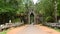 Zoom Out - Vehicles Drive through Archway on Bridge - Angkor Wat, Cambodia