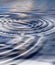 Zoom in on a ripple effect and pattern on a water surface. Creative puddle with abstract circle rings, calm, peaceful