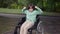 Zoom in serious Caucasian disabled boy in wheelchair gesturing strength gesture looking at camera. Portrait of confident