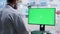 Zoom in shot on doctor typing on green screen computer