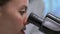 Zoom in side view video of Medical Research Scientist Looking under the Microscope in the Laboratory.