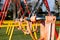 Zoom in on the swings in the playground next to a school in Heywood England