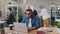 Zoom in time-lapse of creative guy working in office using laptop at desk
