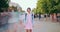 Zoom in time lapse of pretty teenager standing in street with backpack