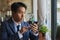 Zoom View Front Right Asian Businessman Touch Smartphone in Coffee Shop Scene