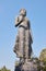 Zoom View Portrait Front Right Buddha Pacifying Relatives Statue on Blue Sky Background