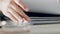 Zoom of woman hands, organise paper or search for document in paperwork stack on table at work. Lady use fingers to find