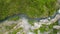 Zoomed aerial video of river, going through it\'s canyon, full of green vegetations