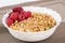 Zoomed golden cereals with berries with spoon