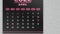 Zooming in of a black beautiful April page of the calendar 2022 and Easter date marked with pink