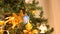 Zooming in from out of focus to close up on Christmas tree with garlands