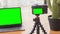 Zooming out footage on camera with chromakey screen on tripod
