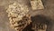 Zooming to Stack of biscuit crackers with sunflowers seeds and sesame, brown background