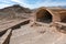 Zoroastrian Tower of Silence with stairs and tomb in the foreground, city of Yazd, Iran. Ancient persian burial site on a hot