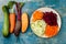 Zucchini, carrot, sweet potato and beetroot noodles on a plate. Top view, overhead. Blue rustic background.