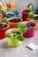 Zucchini courgette or squash seedlings  growing in colorful pots. Ready to planting out. Gardening concept. Copy space