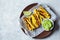Zucchini fries with guacamole on wooden plate gray background. Vegan food concept