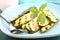 Zucchini grilled on a blue plate with basil