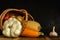 zucchini in a lying wicker basket. traditional autumn still life of vegetables on a black concrete background. artistic dark