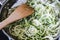 Zucchini noodles cooking in pot on stovetop
