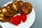 Zucchini pancakes with tomatoes stack on white plate. Vegetable harvesting concept