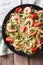 Zucchini pasta with shrimp and tomato close-up. Vertical top vie