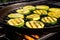 zucchini slices sizzling on a portable grill pan
