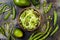 Zucchini spaghetti or noodles zoodles bowl with green veggies and garlic scape pesto. Top view, overhead.