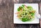 Zucchini spaghetti salad with basil and paprica on squared plat