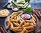 Zucchini sticks on a black plate with ketchup