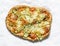 Zucchini, tomatoes, mozzarella cheese crispy tortilla vegetarian pizza on a light background, top view
