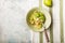 Zucchini Vegetable noodles - green zoodles or courgette spaghetti  with shrimps on plate over gray background. Clean eating, raw