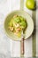 Zucchini Vegetable noodles - green zoodles or courgette spaghetti  with shrimps on plate over gray background. Clean eating, raw