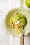 Zucchini Vegetable noodles - green zoodles or courgette spaghetti  with shrimps on plate over gray background. Clean eating, raw