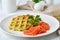 Zucchini waffles with salmon, fodmap diet side view closeup