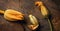 Zucchini yellow flowers on solid wood cutting board, tree bark on rust background.