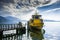 Zug, Switzerland - September 2016: Blue sky, clouds and reflections. Yellow barge anchored at pier on Lake Zug