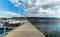 Zug, ZG / Switzerland - 20 April, 2019: people walk to their boat on the harbor docks on the Zugersee lake with a great view of